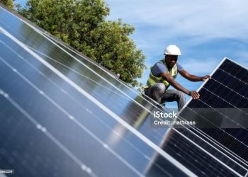 An African Engineer installing solar panels on the roof of a residential house in Cape Town, South Africa. Alternative energy solutions are critical during load shedding in South Africa